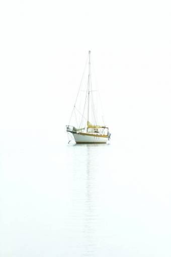 peaceful Sailboat sailing in the calm sea