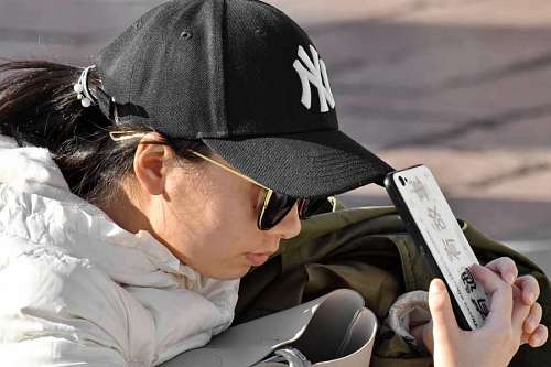 scale asian cellphone hat side sunglasses outdoors woman 
