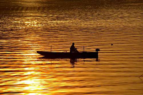 fisher boat shadow golden silhouette dawn beach fisherman horizon glow dusk cloud