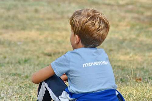 boy blonde child relaxing nature grass sitting schoolboy outdoors