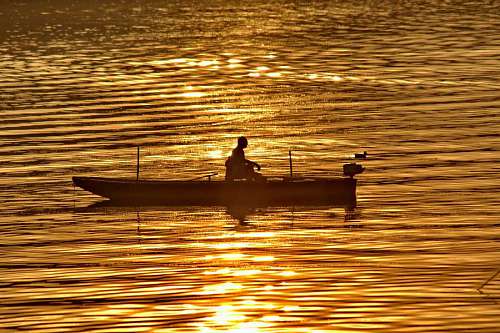 fisher fisherman evening boat dawn glow sunset golden water reflection lake sun