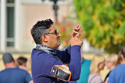 handsome asian portrait eyeglasses side hands street outdoors beard mouth face 