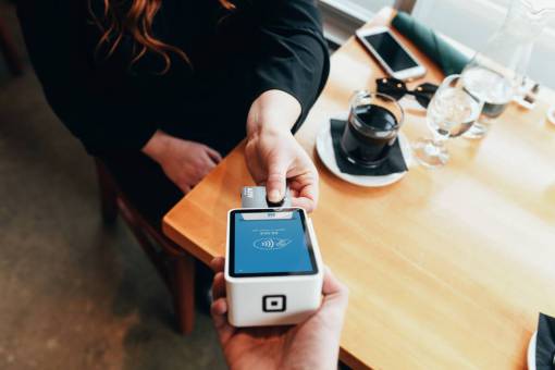 Woman paying coffee with credit card