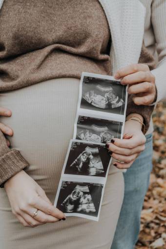 love Pregnant couple showing baby ultrasound