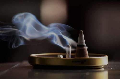 Lighted triangular incense made with rose resin and incense