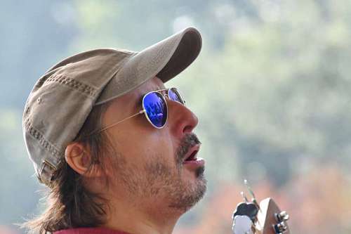 singer guitarist beard handsome concert festival daylight attractive singer portrait face