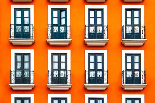 orange Orange colored old building with colonial windows