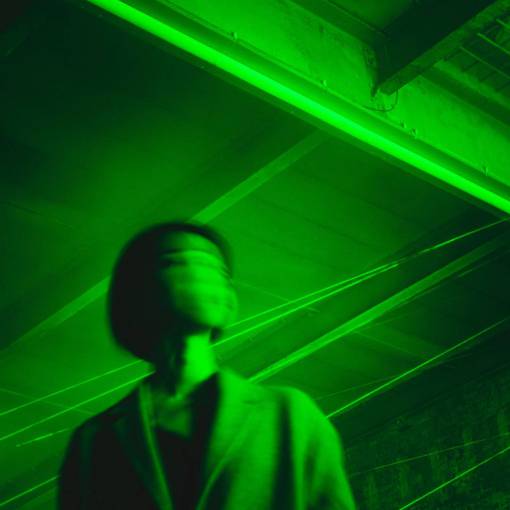 background Woman's face in motion on green light background