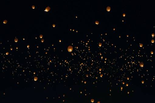 asian-and-indian-ethnicities Lanterns lit in the night sky