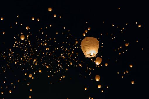asian-and-indian-ethnicities Lanterns lit in the night sky