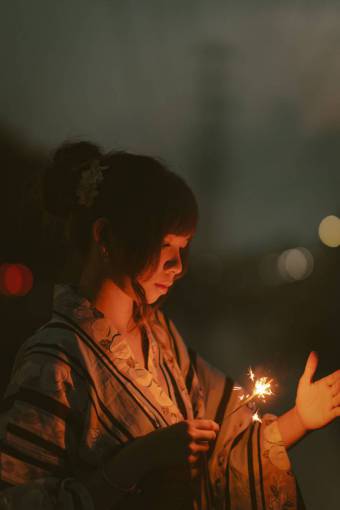 asian-and-indian-ethnicities Woman holding lit sparkler