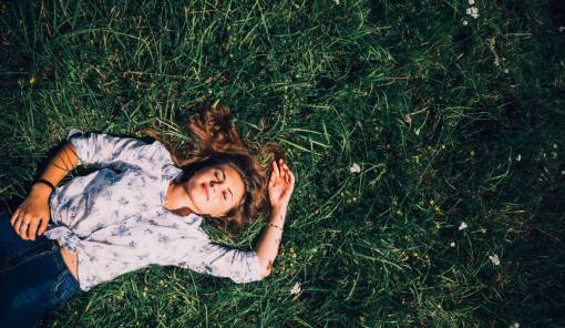 sunlight Woman with eyes closed lying outdoors