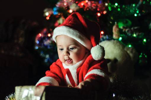 Baby opening presents at christmas