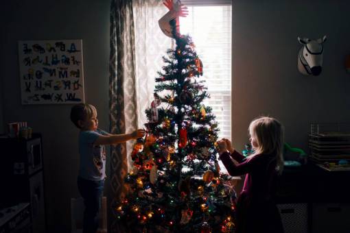 Children decorating christmas tree