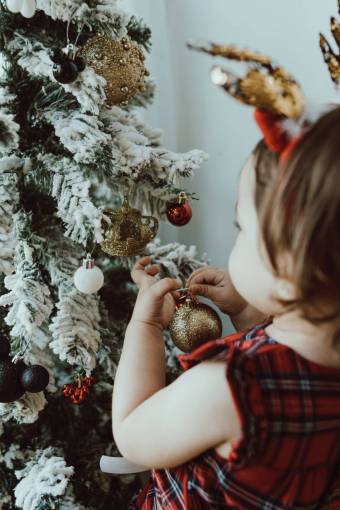 Girl decorating christmas tree