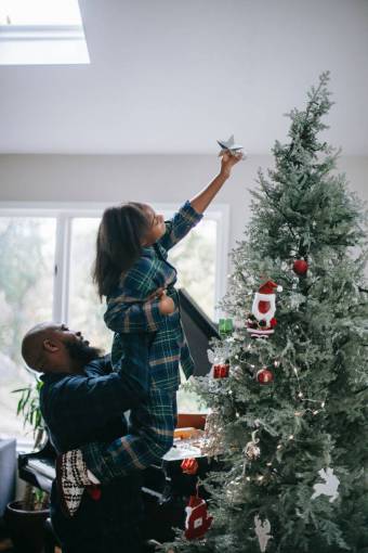 Girl decorating christmas tree