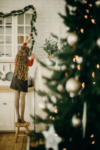 Girl decorating christmas tree