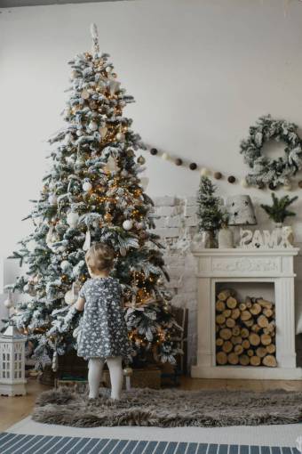 Girl decorating christmas tree