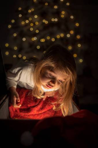 Little girl with her face lit up at christmas