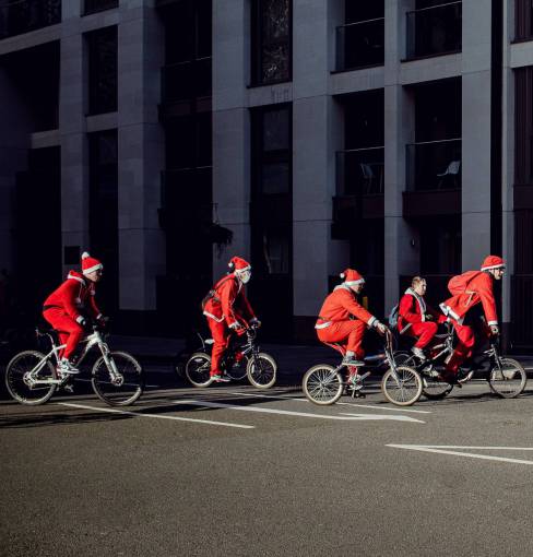 bicycle People dressed as santa claus riding bicycles in the city