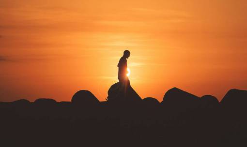 silhouette Man alone walking at dusk