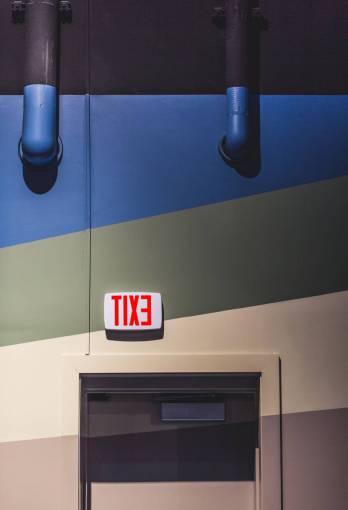 direction exit  sign  door  wall  interior  room  signage