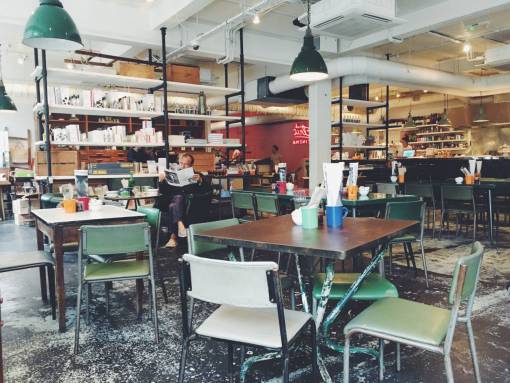 newspaper table  chairs  indoor  inside  people  man  reading