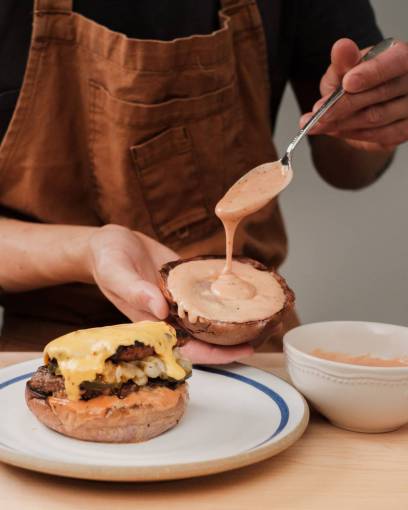 elaborate Chef preparing gourmet burger