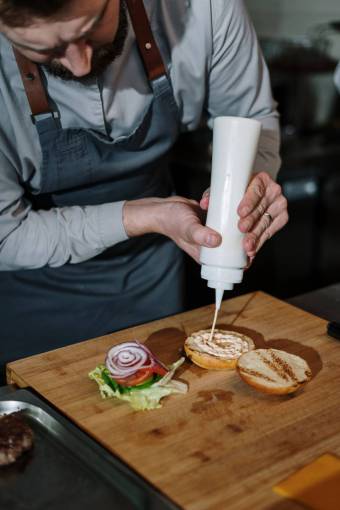 elaborate Chef preparing gourmet burger