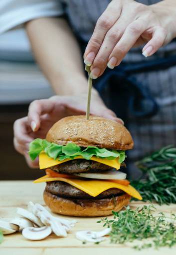 elaborate Chef preparing gourmet burger