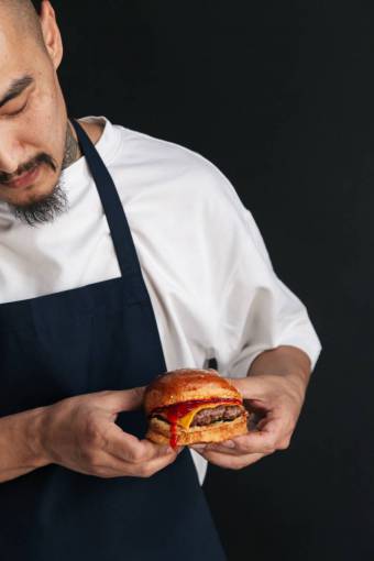 elaborate Chef preparing gourmet burger