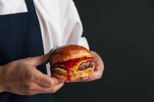 elaborate Chef preparing gourmet burger