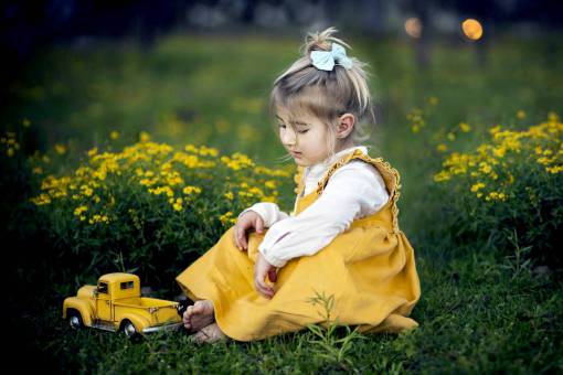 girl Girl playing with a truck in the garden