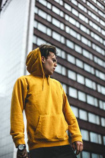 hood Man wearing yellow hoodie outdoors