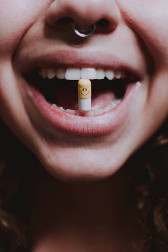 medicine Woman biting pill