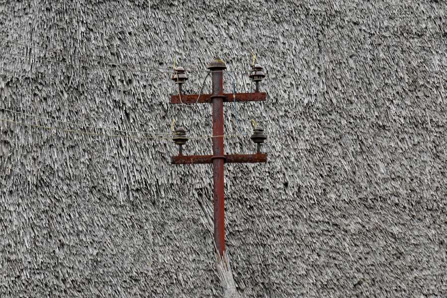 electricity, rooftop, rust, straw, wires 