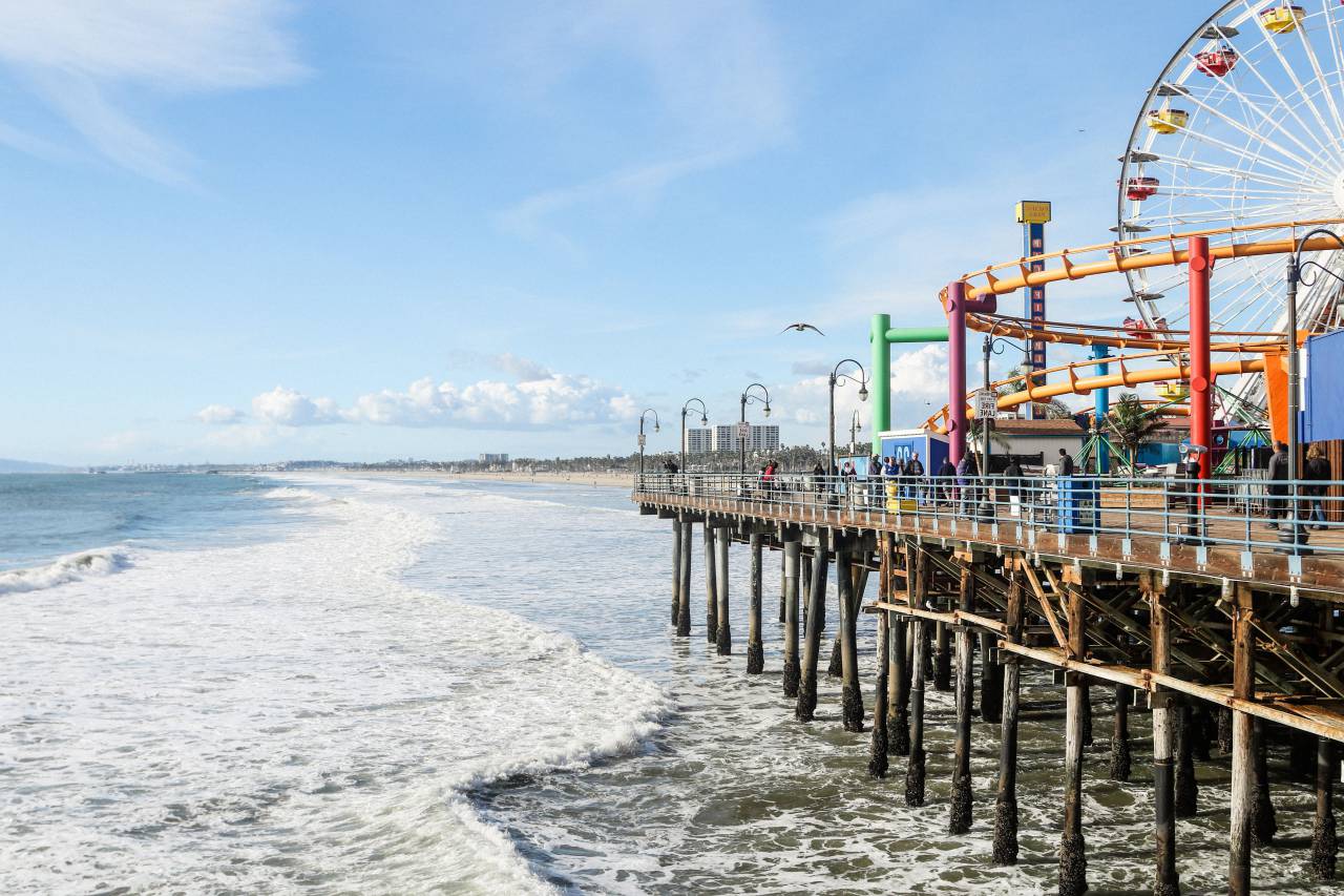 architecture, building, infrastructure, structure, establishment, amusement park, ferris wheel, waves, ocean, sea, beach, clouds, sky, bird, rides, bridge
, 