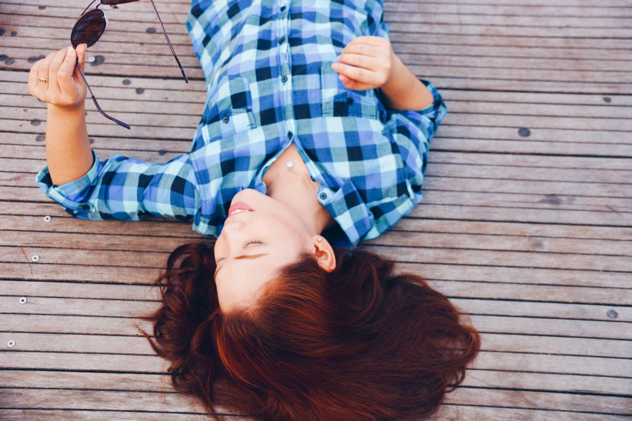 girl, woman, smile, smiling, happy, people, brunette, long hair, plaid, shirt, fashion, clothes, sunglasses, wood, deck, outdoors, lying down
, 