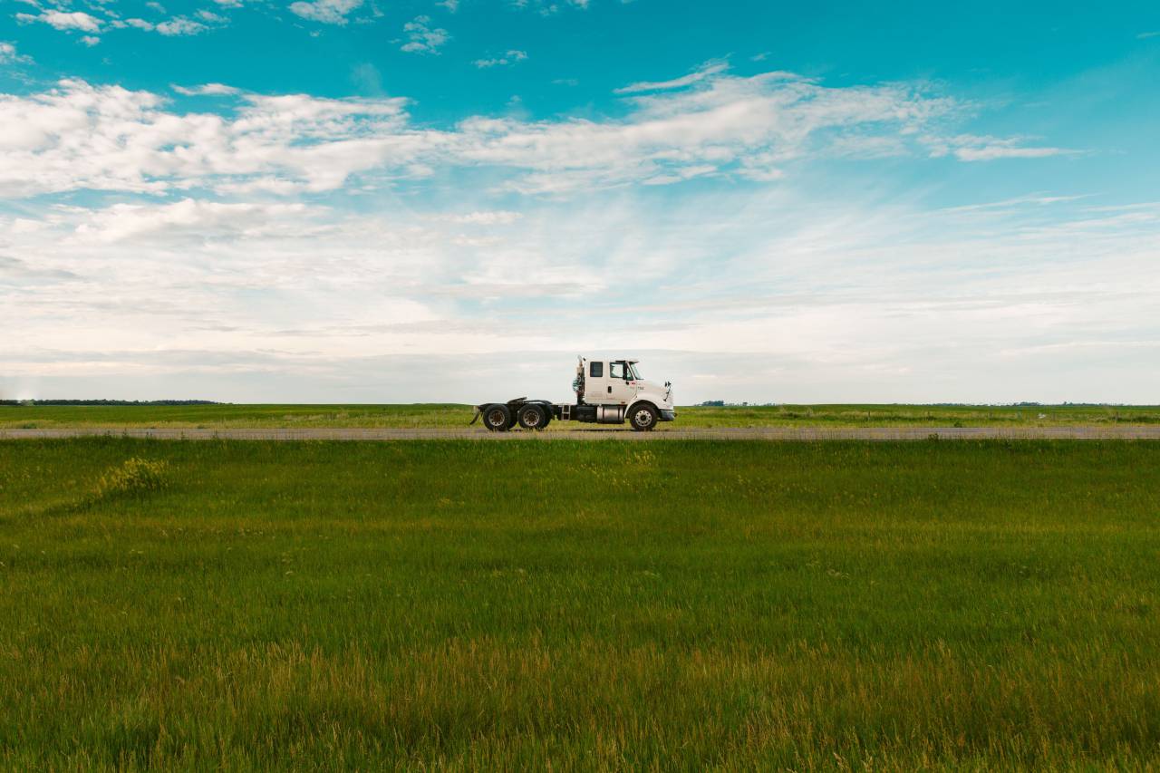 truck;countryside,nature,industry,rural scene,outdoors,agriculture,machinery,working,equipment,farm,land vehicle,transportation,meadow,tractor,grass,summer,landscape,mode of transport,truck,land,blue,car, 