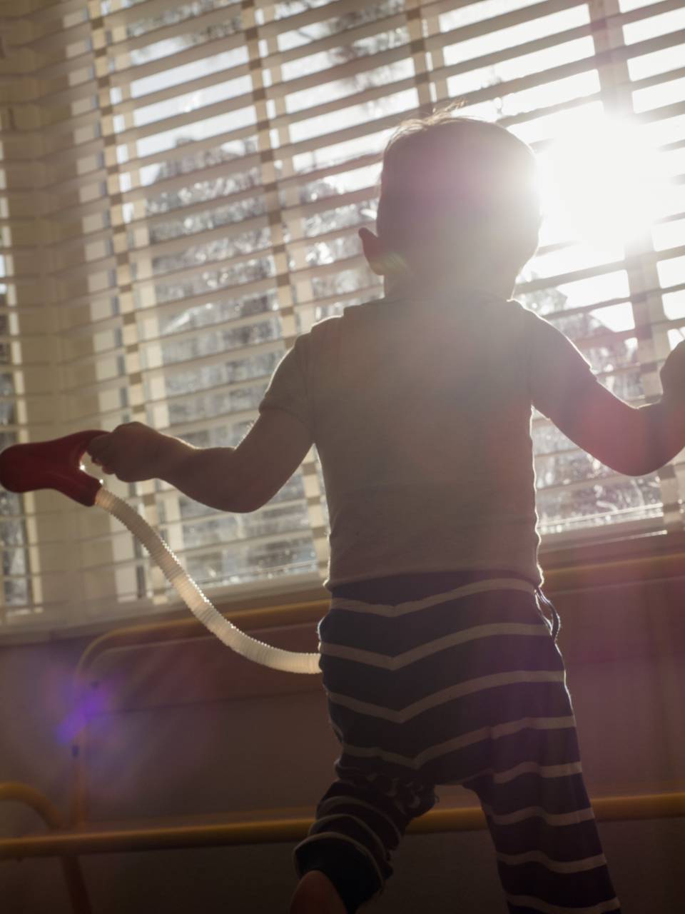 Little Boy, Playing, Home, Window, Back Turned, Indoor Play, Childhood, Joy, Innocence, Imagination, Curiosity, Child Development, Creativity, Playful, Exploration, Home Activities, Family, Leisure, Toddler, Growing Up, Discovery, Window View, Domestic Scene, Privacy, Kids at Home, Indoor Playtime, Child's Play, Happiness, Carefree, Quiet Play, Observing, Home Environment, Peaceful, Serene, Child Safety, Playful Mood, 
