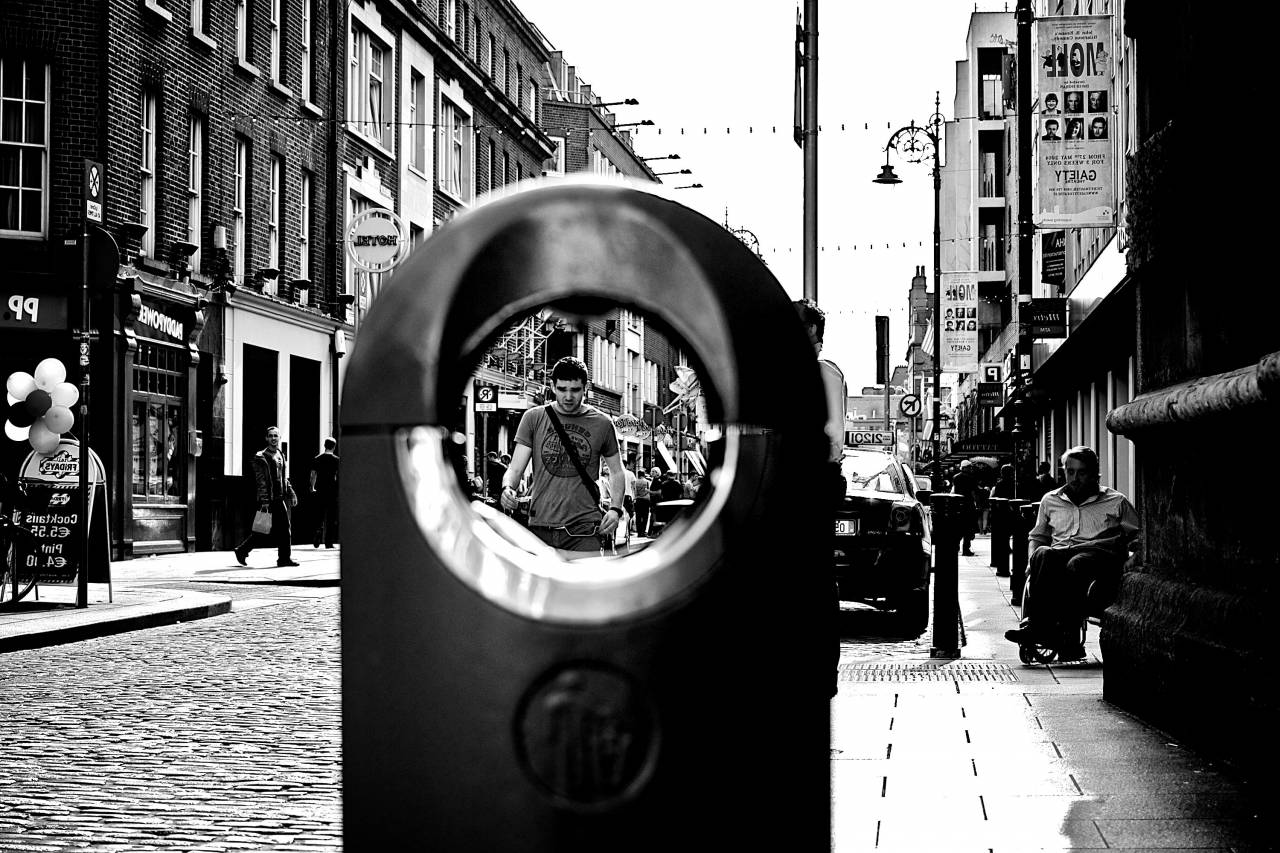 people, city, urban, streets, sidewalk, cobblestone, buildings, stores, shops, apartments, black and white, young, man, guy
, 