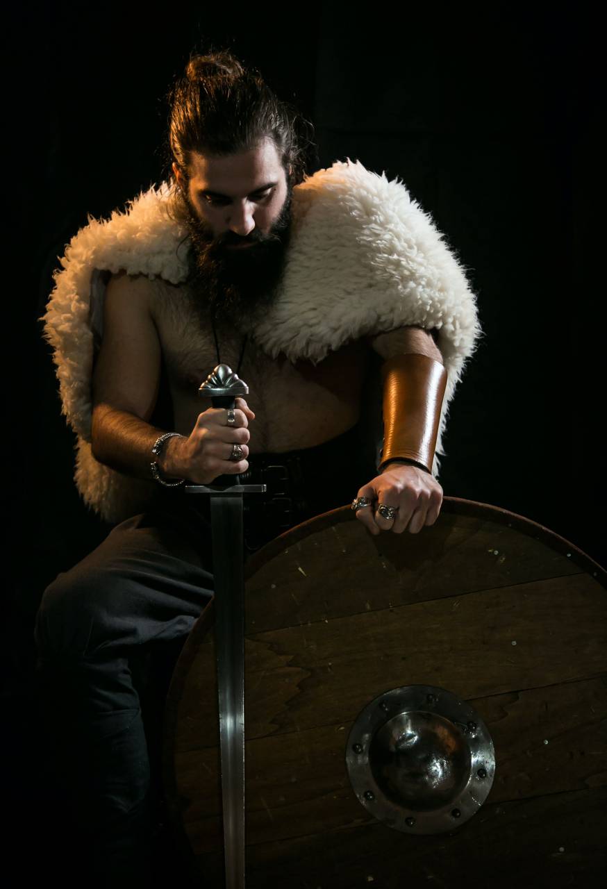 Viking warrior, portrait, battle ready, axe, sword, shield, helmet, armor, chainmail, fur, beard, mustache, long hair, angry, fierce, determined, brave, strong, warrior culture, Norse mythology, Scandinavia, 9th century, 10th century, historical reenactment, 