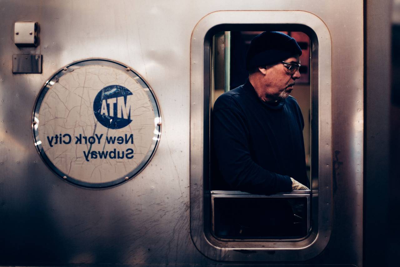 people, man, guy, train, sweatshirt, beanie, travel, transportation, subway, land, beard, steel, glass, window
, 