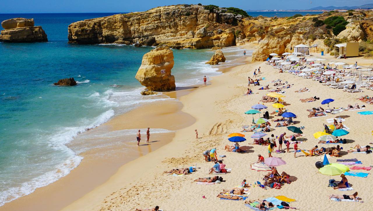 sea, ocean, water, waves, nature, white, sand, beach, coast, shore, people, men, women, crowd, umbrella, summer, vacation, swimming, rocks, cliff, hill
, 