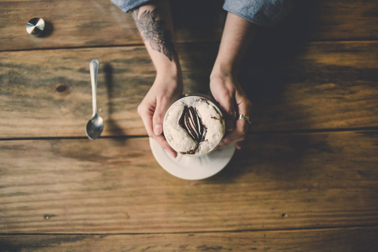 woman, tattoo, coffee, cappuccino, drink, bar, cafe, hold, hands, arms, table, wood, spoon
, 