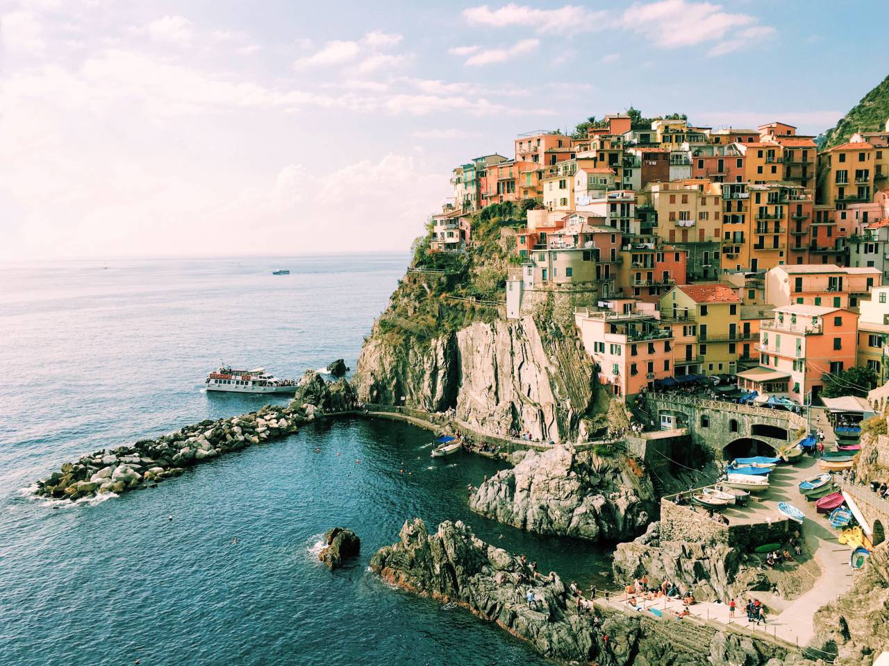 building, house, hotel, apartment, seaside, coast, sea, water, ocean, landscape, people, crowd, men, girls, swimming, vacation, summer, outdoor, boat, ship, rock, hill, road, trees, sky, clouds
, 