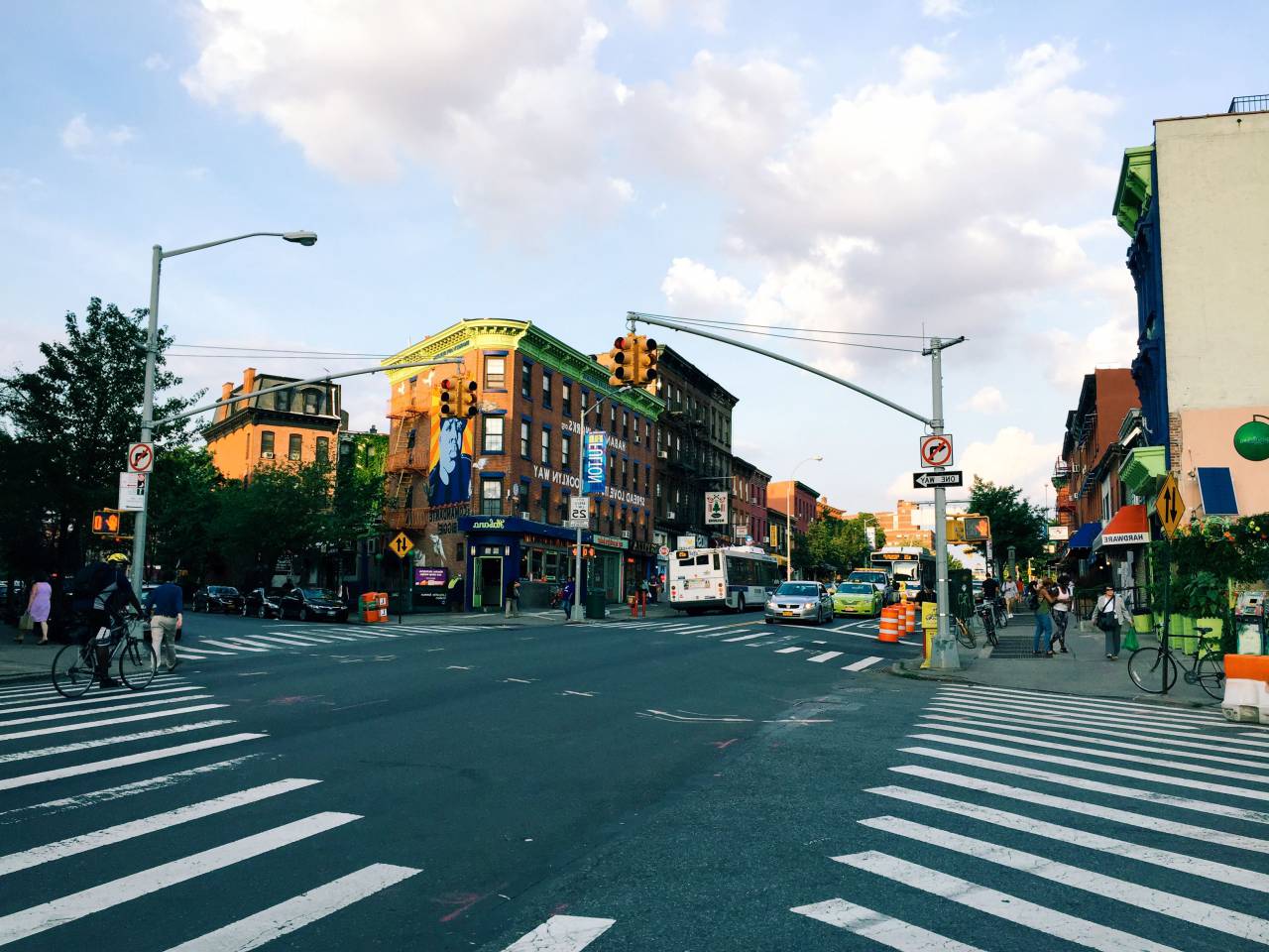 intersection, crosswalk, city, urban, road, street, pavement, cars, trucks, buildings, traffic lights, lamp posts
, 