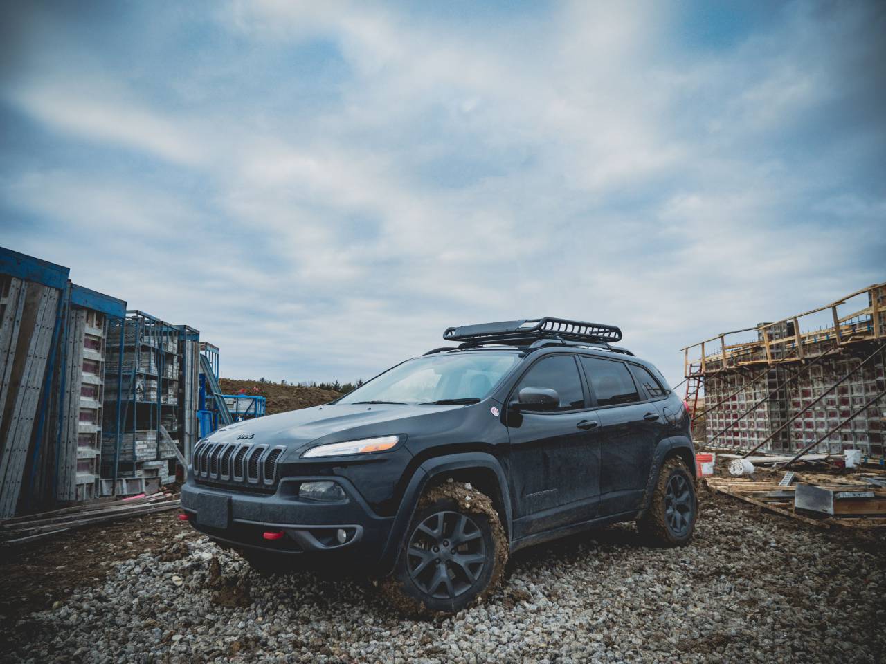car, vehicle, wheels, bumper, construction, architecture, rocks, structure, sky, clouds, mud, woods, steel
, 