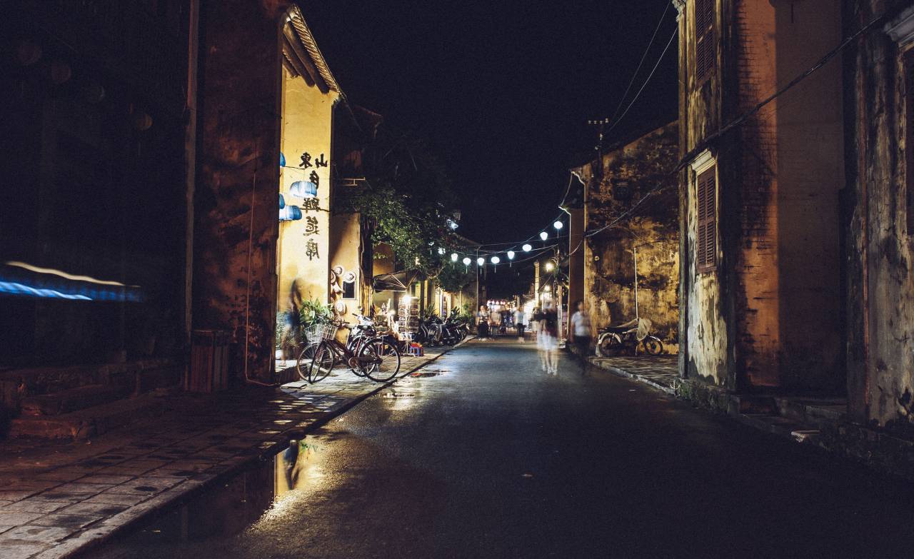 dark, night, asian, town, bike, bicycle, road, street, puddle, wet, shutters, buildings, string lights, people, walking, pedestrians, old, evening
, 
