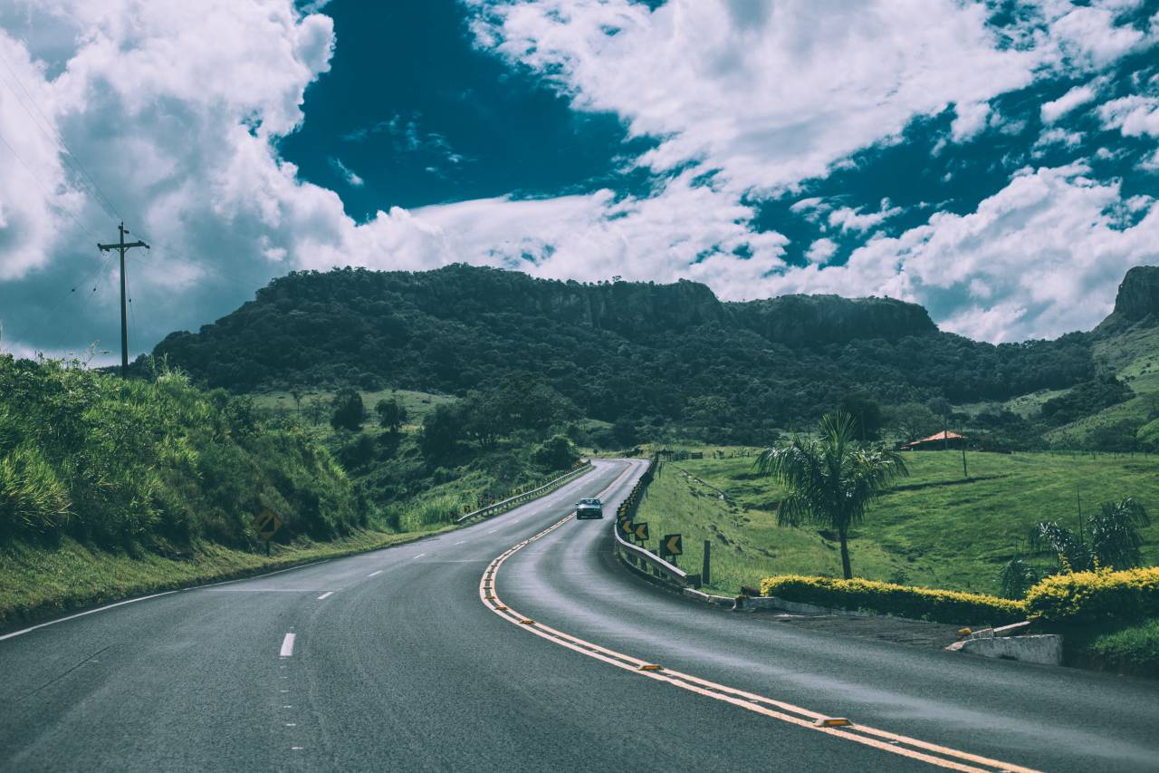 road, highway, cars, driving, green, grass, fields, mountains, hills, sunshine, sky, clouds, outdoors, pavement
, 
